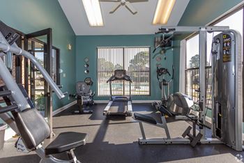 a gym with exercise equipment and a window